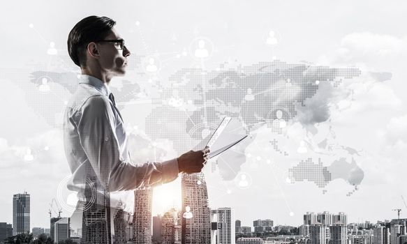 Double exposure of elegant businessman with papers in hands looking away