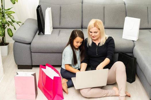 picture of happy mother and child with laptop computer, shopping online