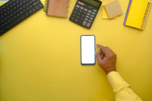 top view of man hand using smart phone on office desk.