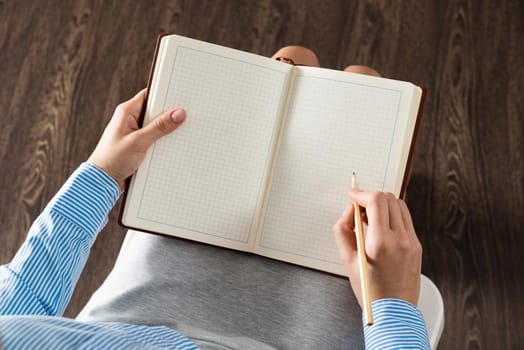 close-up a female hands with notebook and pencil