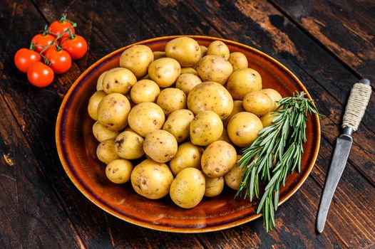 Raw baby mini Potatoes. Dark wooden background. Top view.