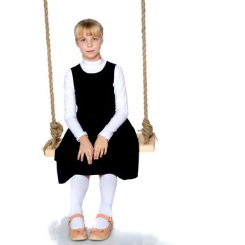 Beautiful little girl swinging on a swing. The concept of family happiness, summer holidays. Isolated on white background.