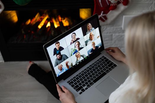 A young smiling woman making video call on social network with family and friends on Christmas day.