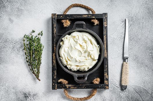 Cream cheese Mascarpone in a wooden tray for tiramisu. White background. Top view.