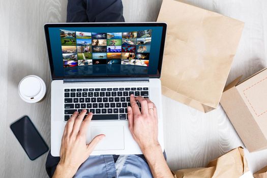 Man watching TV channels by laptop online