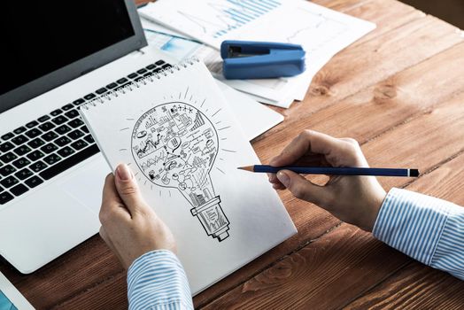 close-up, woman draws business notes in her notebook. Business Innovation Concept