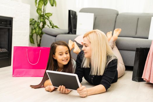Mother and daughter is using tablet for buying thing online black Friday