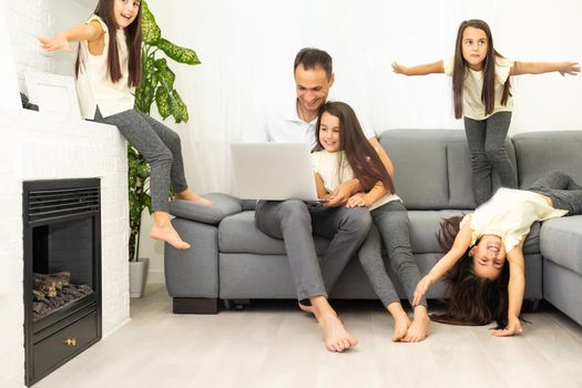 Family shopping online. Happy family smiling while sitting on the couch and shopping online together