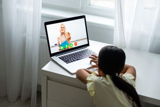 cheerful young little girl children using laptop computer, studying through online e-learning system