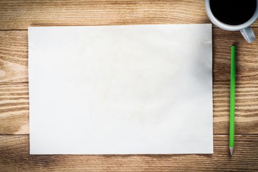 Flat lay wooden table with cup of coffee and paper. Blank white a4 format paper with pen. Space for writing and notification. Textured natural wooden background. Vintage copy space for creative design