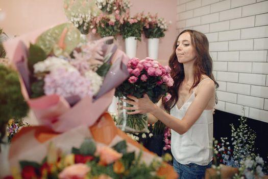 Girl with a flowers. Florist making a bouquet