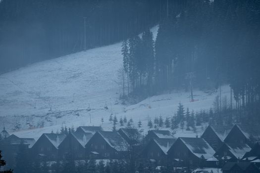 family with snowboards at winter resort