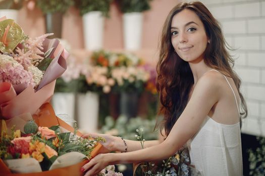 Girl with a flowers. Florist making a bouquet