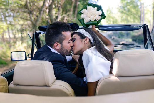 Just married couple together in an old car