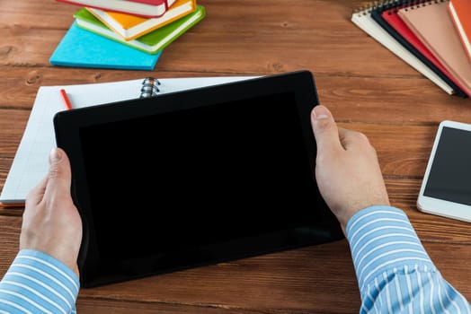 close-up of men's hands with a computer tablet. Businessman works in the office