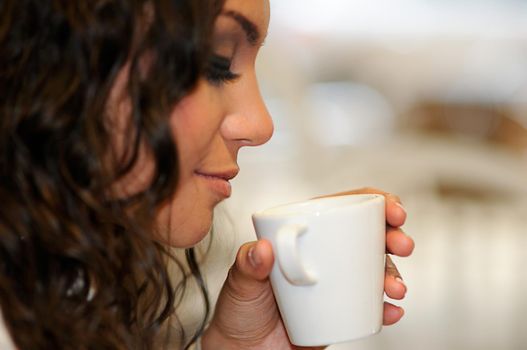 Portrait of beautiful elegant woman with coffee cup