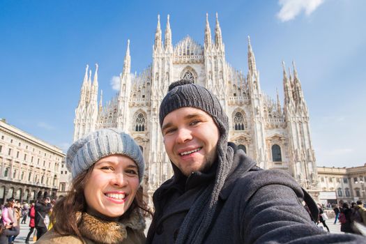 Travel, photographing and people concept - Happy couple taking self portrait in Duomo square.