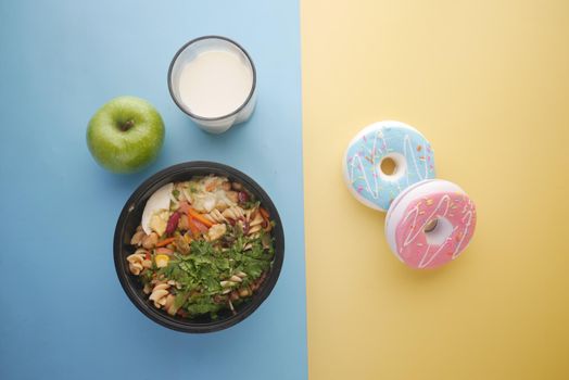 comparing healthy and junk food concept on table .