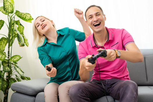 Couple playing video games at home