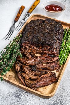 Brisket BBQ beef meat sliced on a wooden tray. White background. Top view.