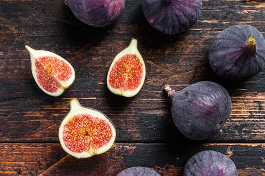 Portion of fresh Figs on vintage wooden table. Dark wooden background. Top view.