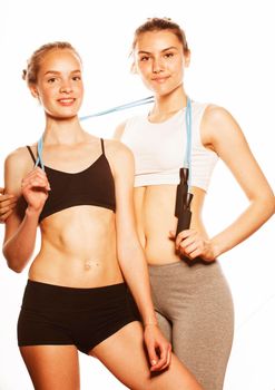 two sport girls measuring themselves isolated on white, inflated press