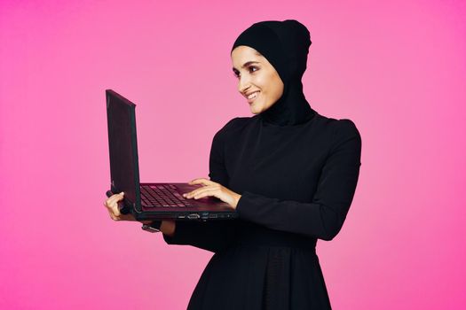 cheerful muslim woman with laptop education student internet technology. High quality photo