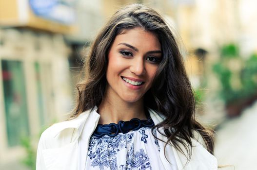 Portrait of a beautiful woman smiling in urban background
