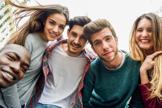 Multiracial group of friends taking selfie in a urban park