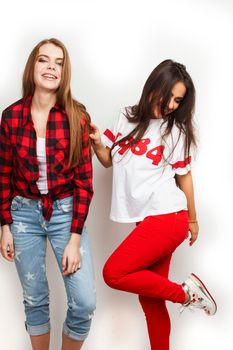 best friends teenage girls together having fun, posing emotional on white background, besties happy smiling, lifestyle people concept, blond and brunette multi nations close up