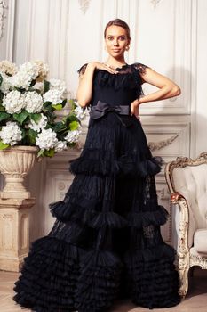 young pretty lady in black lace fashion style dress posing in rich interior of royal hotel room, luxury lifestyle people concept close up