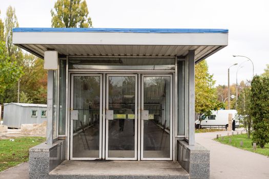The front door of a office block, reflecting buildings in the glass.