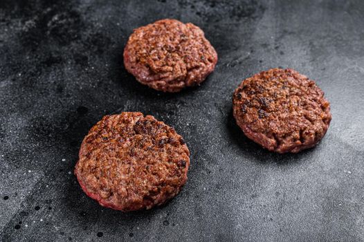 Grilled ground beef steak patties for burgers, Mince meat. Black background. Top view.