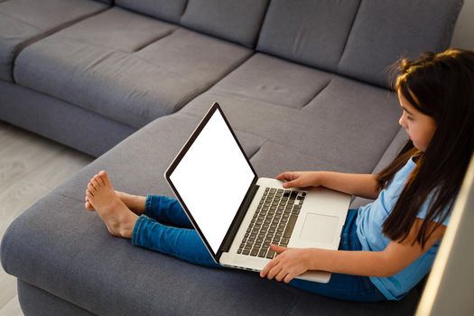 small preschool child with laptop screen blank