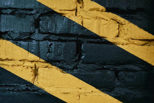 Black brick wall with yellow stripes at gym, background, copy space for text