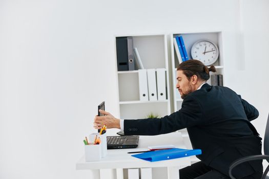 Man workflow in the office documents emotions technology. High quality photo