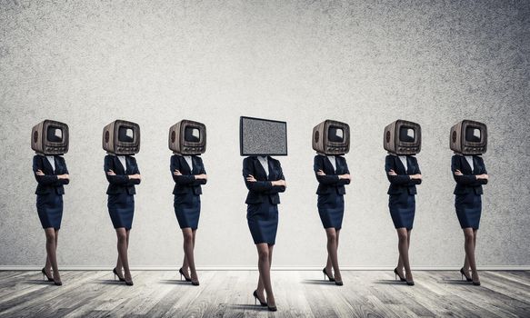 Businessmen in suits with old TV instead of their heads keeping arms crossed while standing in a row