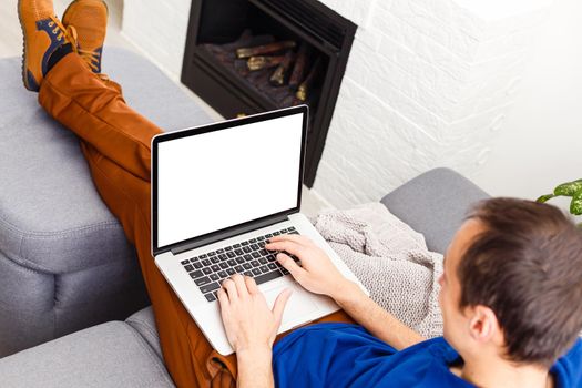 Back view of male person sitting front open laptop computer with blank empty screen for your information or content, modern businessman working in internet