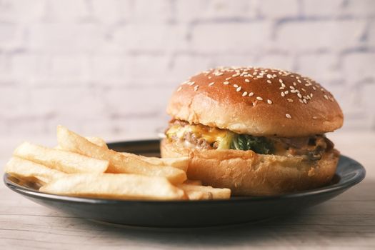 junk foods on plate on wooden table close up ,