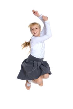 A little girl is jumping and waving her hands. The concept of a happy childhood, outdoor recreation. Isolated on white background.