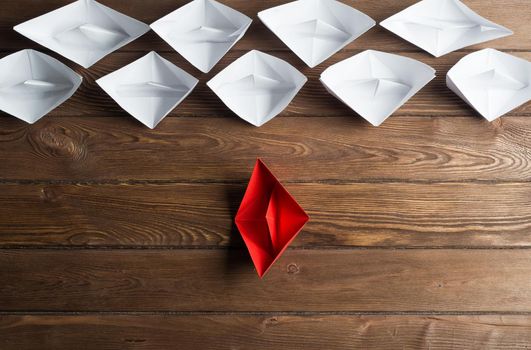 Set of origami boats on wooden table