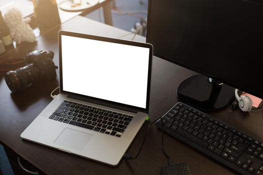 Laptop with blank screen on table