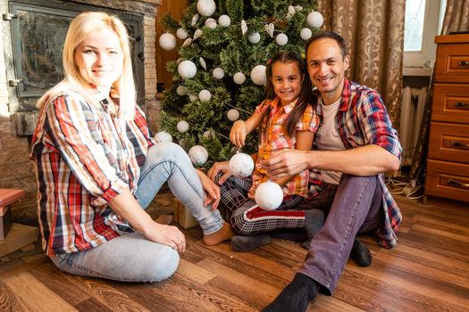 Family in an old wooden house. Beautiful christmas decorations. The festive mood. Christmas holidays.