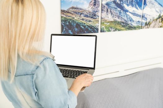Rear view of business woman hands busy using laptop at office desk, with copyspace.