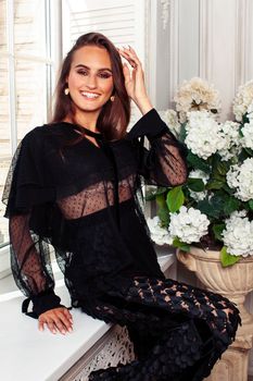 young pretty lady in black lace fashion style dress posing in rich interior of royal hotel room, luxury lifestyle people concept close up