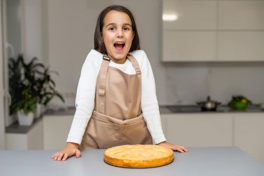 Portrait of cute little girl holding homemade pie
