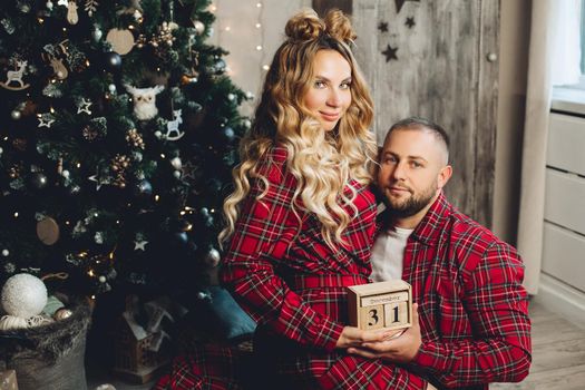 caucasian girl and her boyfriend have fun in christmas atmosphere