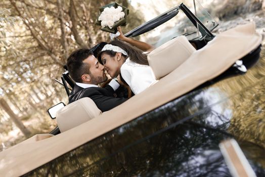Just married couple together in an old car
