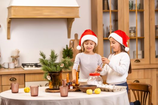 happy sisters children girls two little girls cooking before christmas in the kitchen