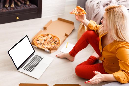 Female person sitting front open laptop computer with blank empty screen for your information or content while talking on smart phone, businesswoman work on notebook at breakfast in modern coffee shop
